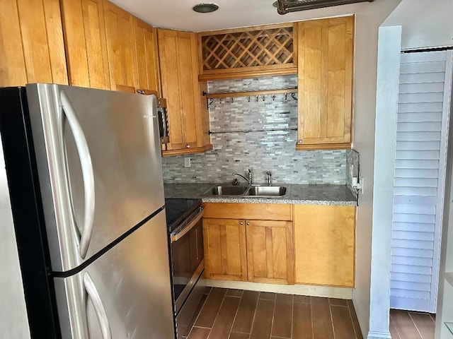 kitchen featuring stainless steel appliances, sink, and backsplash