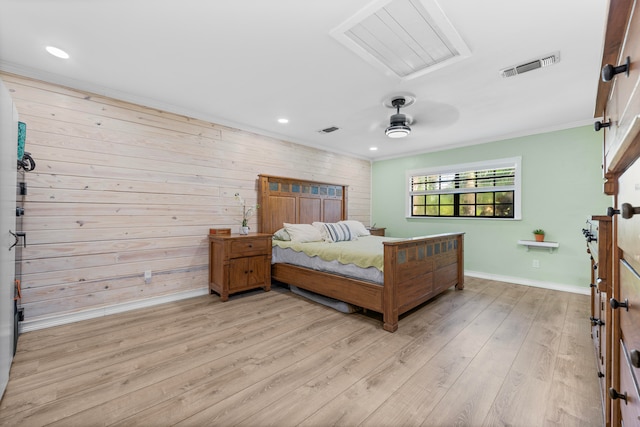 bedroom featuring light hardwood / wood-style flooring, ceiling fan, ornamental molding, and wooden walls