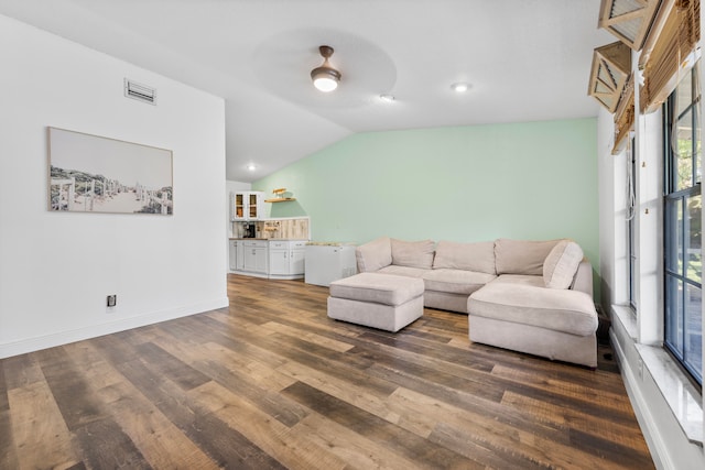 living room with lofted ceiling, ceiling fan, and dark hardwood / wood-style floors