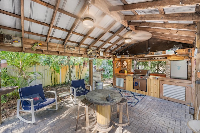 view of patio with exterior kitchen and ceiling fan