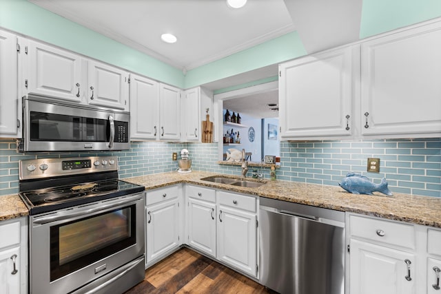 kitchen with dark wood-type flooring, light stone counters, appliances with stainless steel finishes, and tasteful backsplash