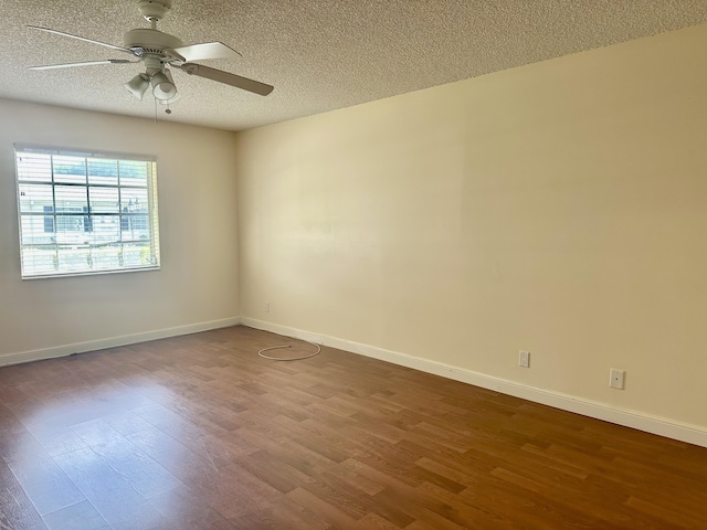 empty room featuring ceiling fan, wood-type flooring, and a textured ceiling