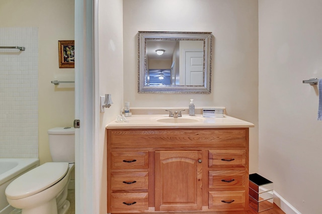 bathroom featuring vanity, a washtub, and toilet