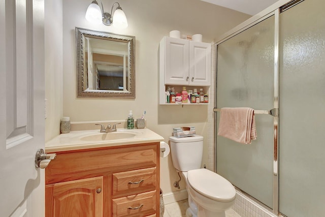 bathroom featuring a shower with door, vanity, and toilet