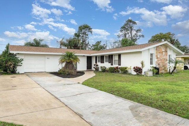 ranch-style house featuring a garage and a front lawn