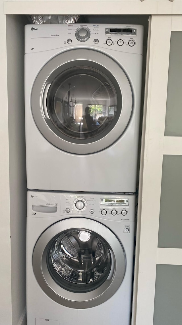 laundry area with stacked washer / drying machine