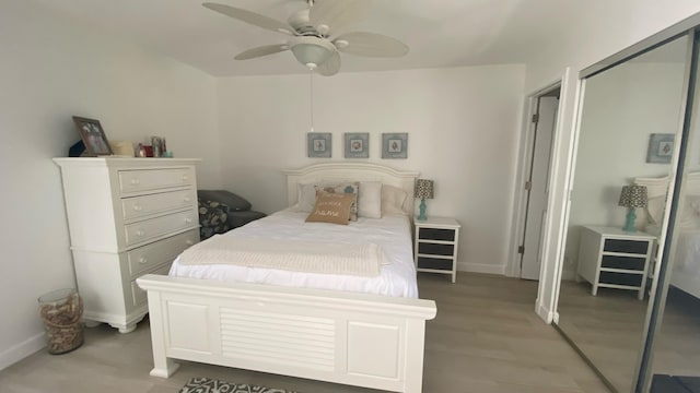 bedroom featuring a closet, ceiling fan, and hardwood / wood-style flooring