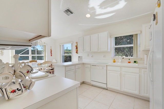 kitchen featuring kitchen peninsula, white cabinetry, sink, and white appliances