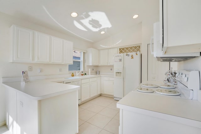 kitchen with kitchen peninsula, white appliances, sink, light tile patterned floors, and white cabinetry