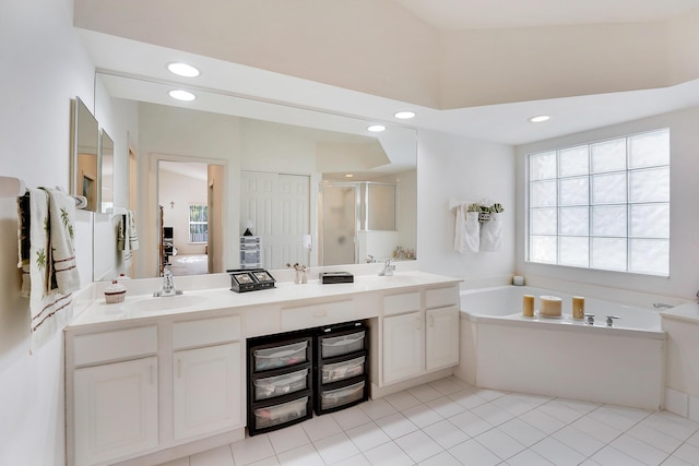 bathroom with tile patterned floors, separate shower and tub, and vanity