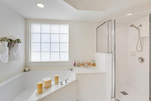 bathroom featuring plenty of natural light and plus walk in shower