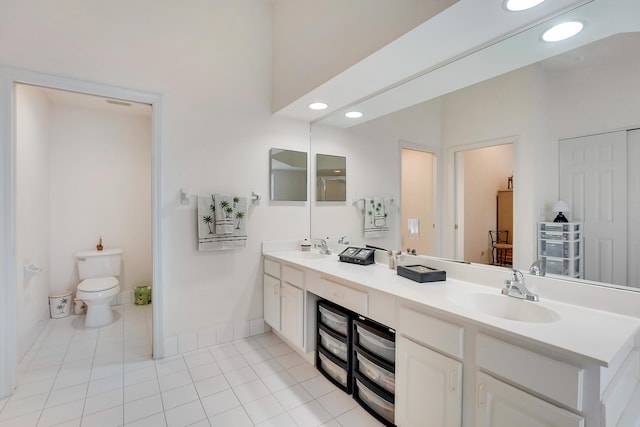 bathroom with tile patterned floors, vanity, and toilet