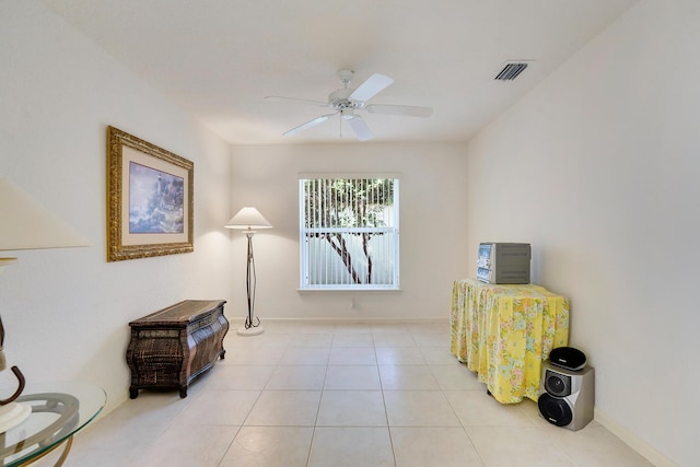 living area featuring ceiling fan and light tile patterned flooring