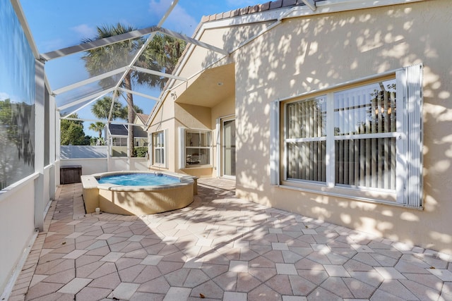 exterior space with a hot tub and a lanai