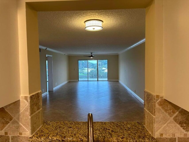 unfurnished room featuring crown molding, a textured ceiling, and tile patterned floors