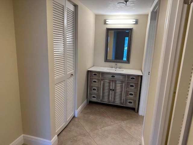 bathroom with tile patterned floors and vanity