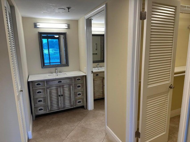 bathroom with tile patterned flooring and vanity