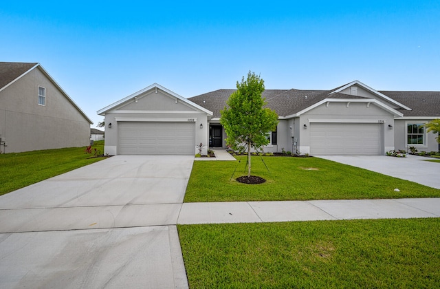 ranch-style house featuring a garage and a front lawn