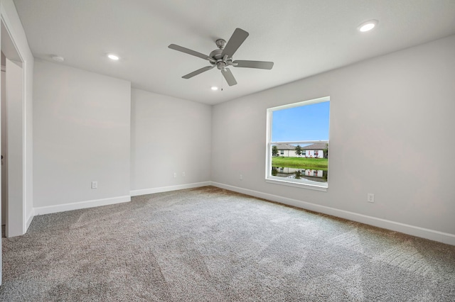 unfurnished room with ceiling fan and carpet floors