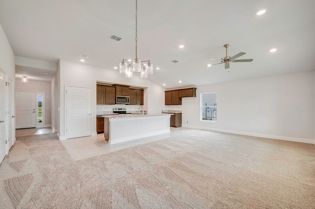 kitchen featuring pendant lighting, ceiling fan with notable chandelier, stainless steel appliances, and light colored carpet