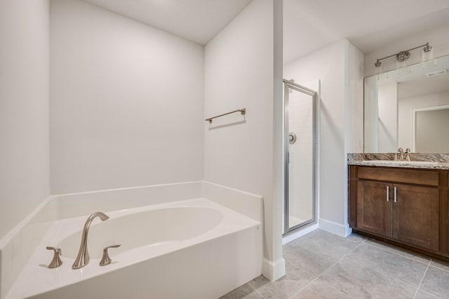 bathroom with tile patterned flooring, vanity, and shower with separate bathtub