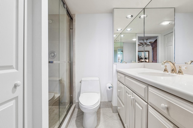 bathroom with vanity, ceiling fan, tile patterned flooring, toilet, and a shower with shower door