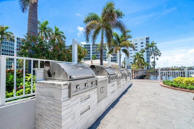 view of patio featuring area for grilling, a water view, and grilling area