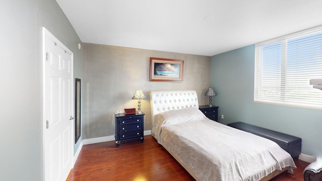 bedroom with dark hardwood / wood-style flooring