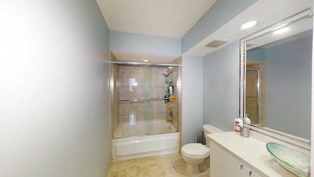 full bathroom with shower / bath combination with glass door, vanity, toilet, and tile patterned floors