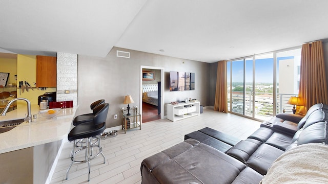 living room with floor to ceiling windows and sink