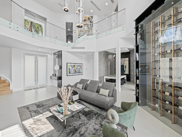 living room with french doors, a high ceiling, and visible vents