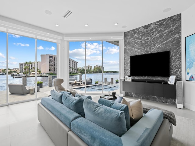 living room featuring a wealth of natural light, floor to ceiling windows, visible vents, and recessed lighting