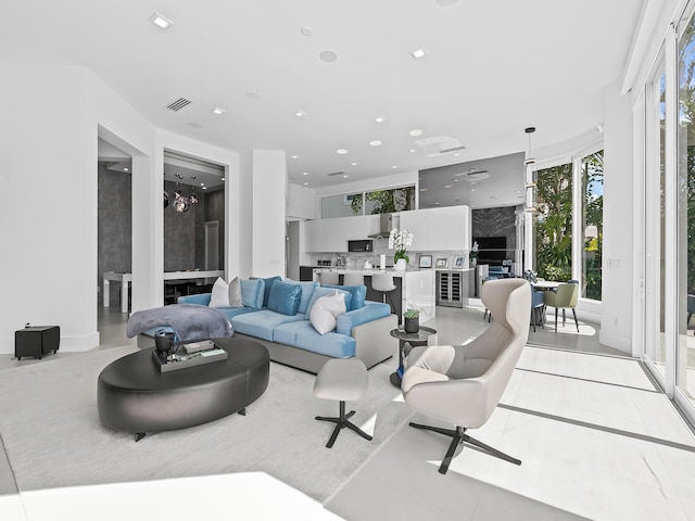 living room featuring light tile patterned floors, visible vents, and recessed lighting