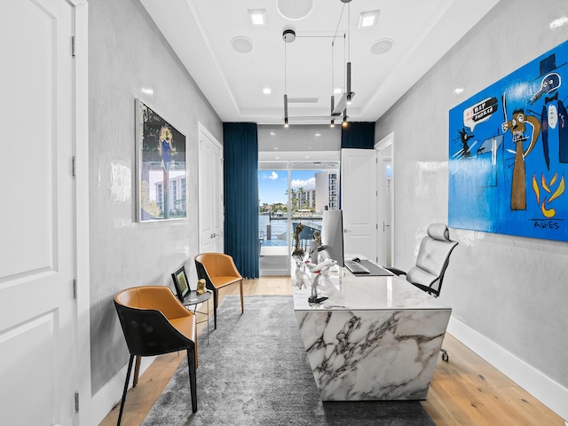 office area with baseboards and wood finished floors