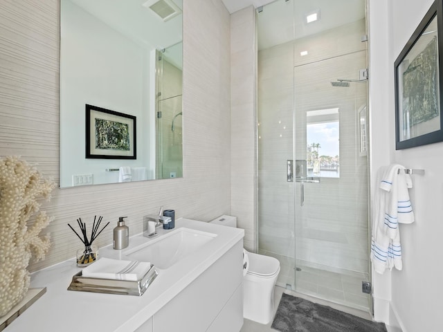 full bathroom with a stall shower, visible vents, vanity, and toilet