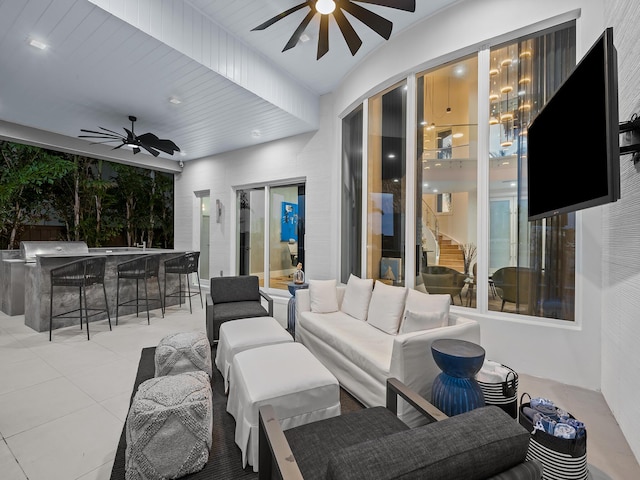 view of patio with outdoor dry bar, an outdoor living space, and a ceiling fan