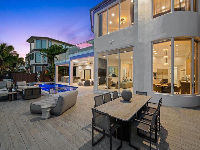 exterior space with a fenced in pool, outdoor dining area, fence, a balcony, and an outdoor living space