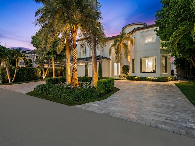 mediterranean / spanish-style house featuring driveway and stucco siding