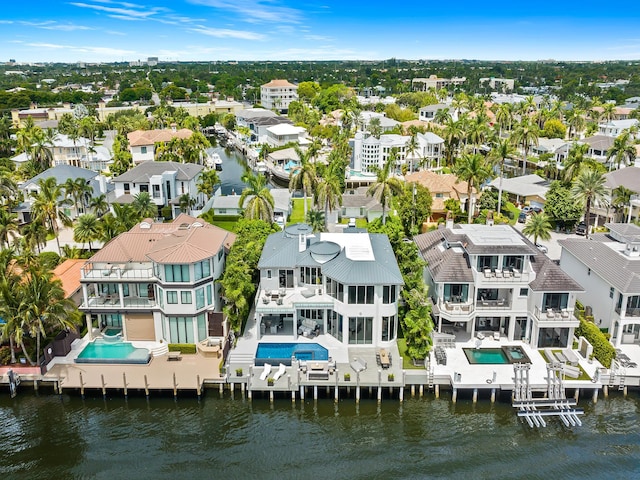 birds eye view of property with a water view and a residential view