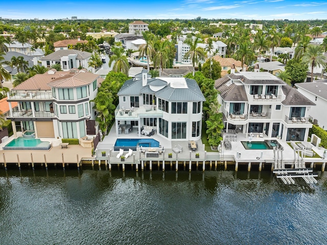 bird's eye view featuring a water view and a residential view