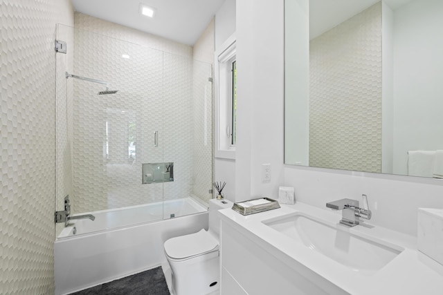 full bath featuring shower / bath combination with glass door, vanity, and toilet