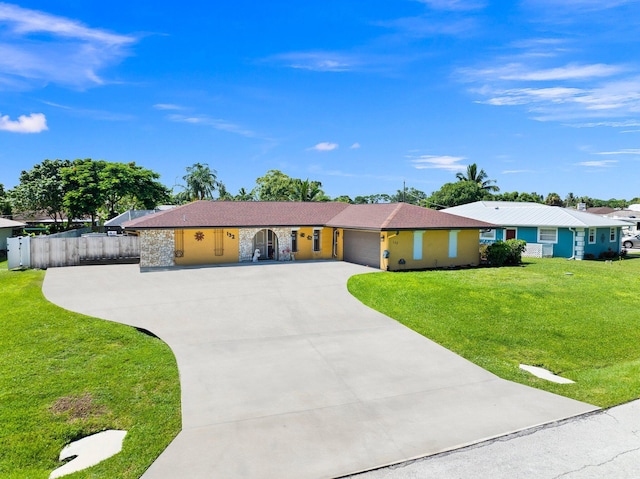 ranch-style home featuring a garage and a front lawn