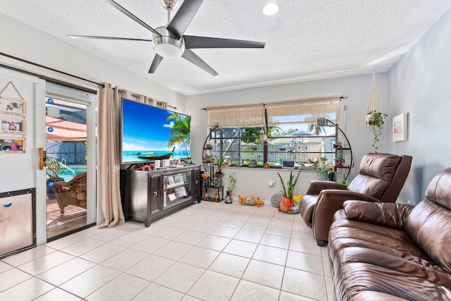 tiled living room with ceiling fan and a textured ceiling