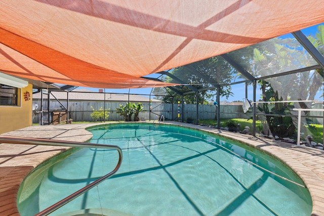 view of pool featuring a patio area and glass enclosure