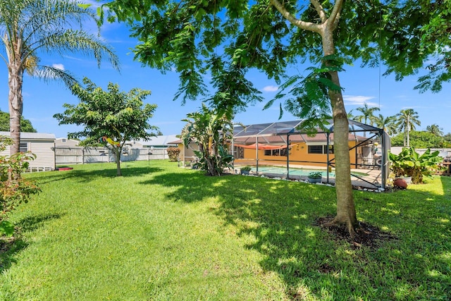 view of yard with a swimming pool and glass enclosure