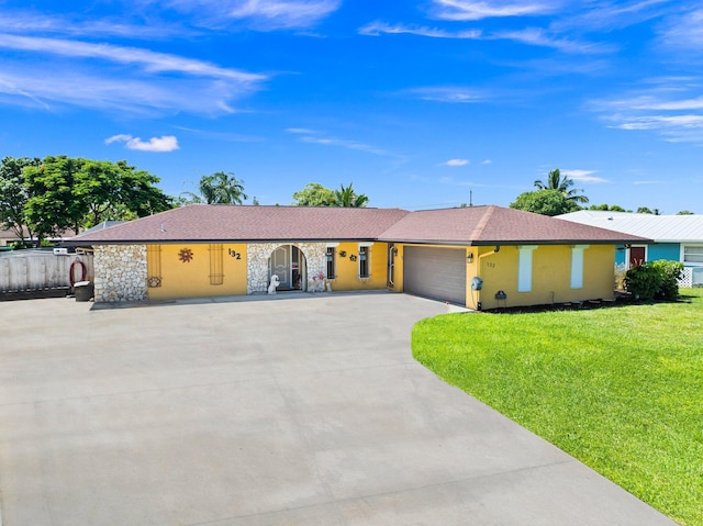 single story home with a garage and a front yard