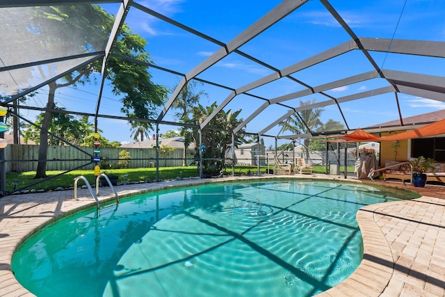 view of swimming pool featuring a lanai and a patio area