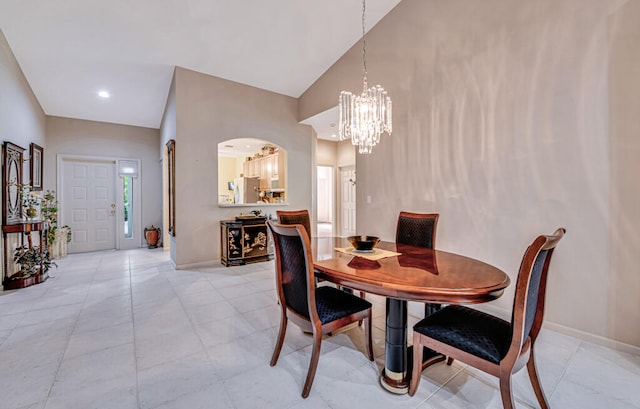 dining space with a chandelier and high vaulted ceiling