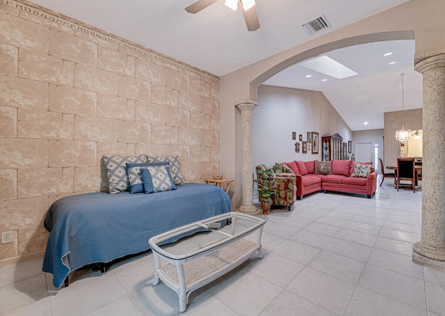 bedroom with lofted ceiling, decorative columns, ceiling fan with notable chandelier, and tile patterned floors