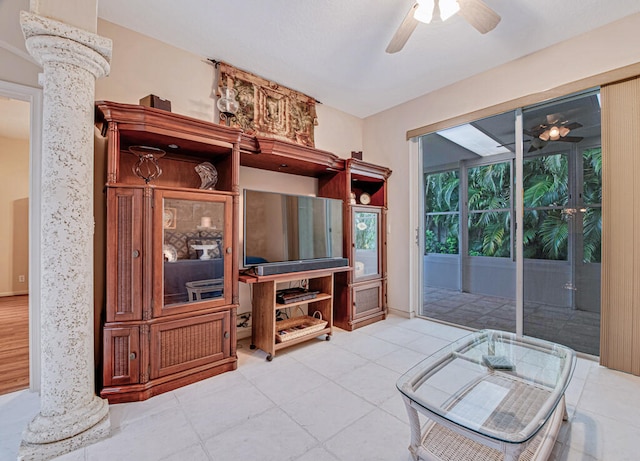 living room with decorative columns and ceiling fan